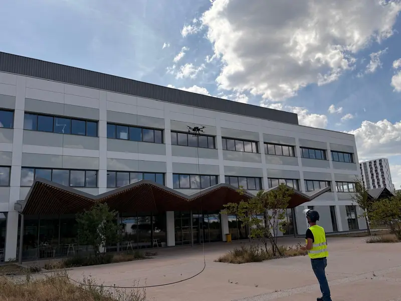 Wide view of the office building with drone and pilot