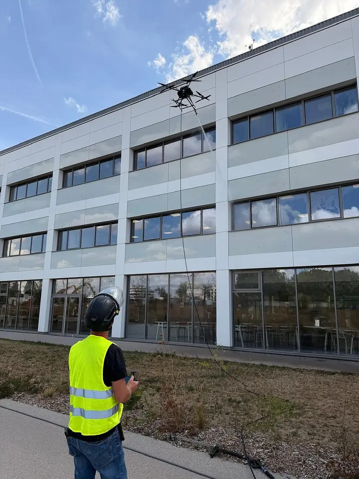 Drone pilot on the ground in front of the research centre façade