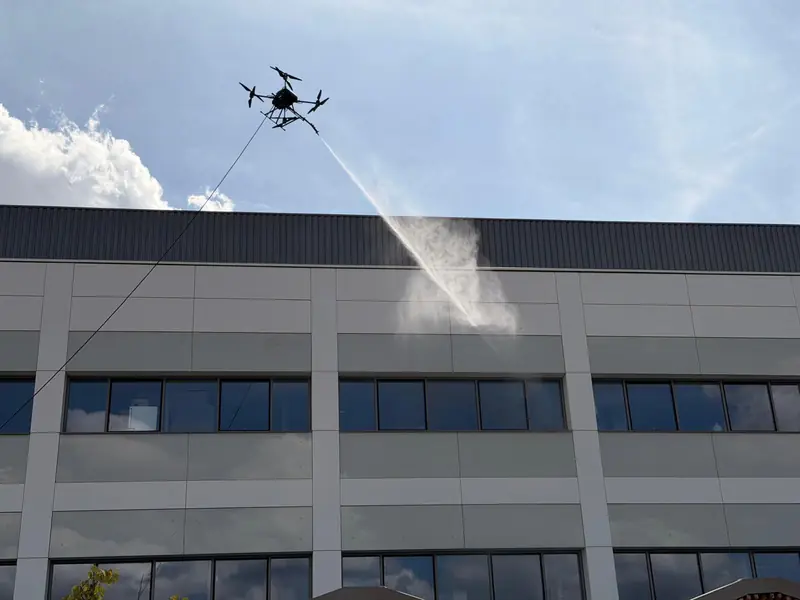 Drone spraying office windows from close range